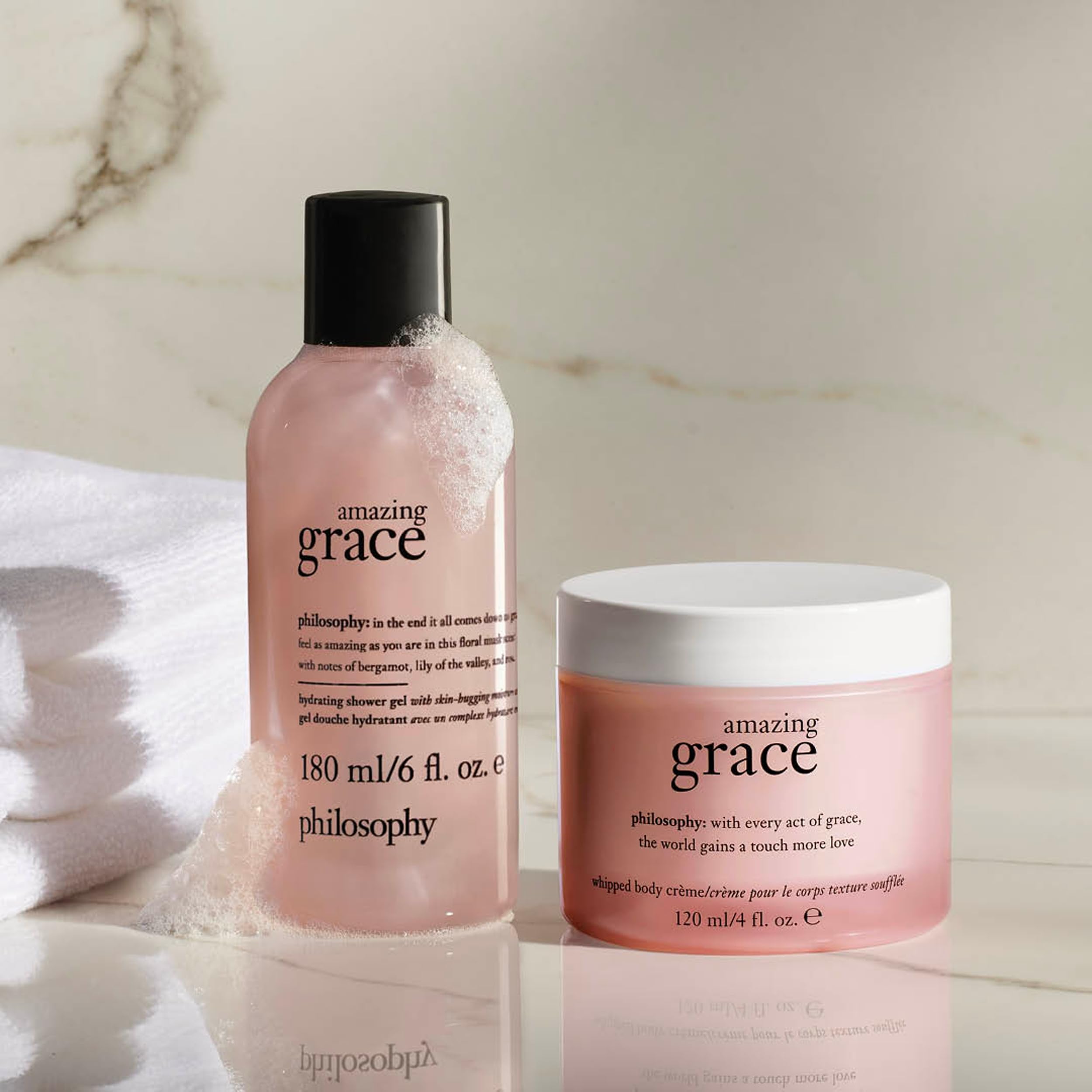Close up of the Philosophy whipped body crème open jar revealing the thick white moisturizer texture