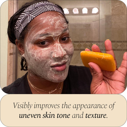 Glo Melanin dark spot corrector soap bar displayed on a bathroom counter