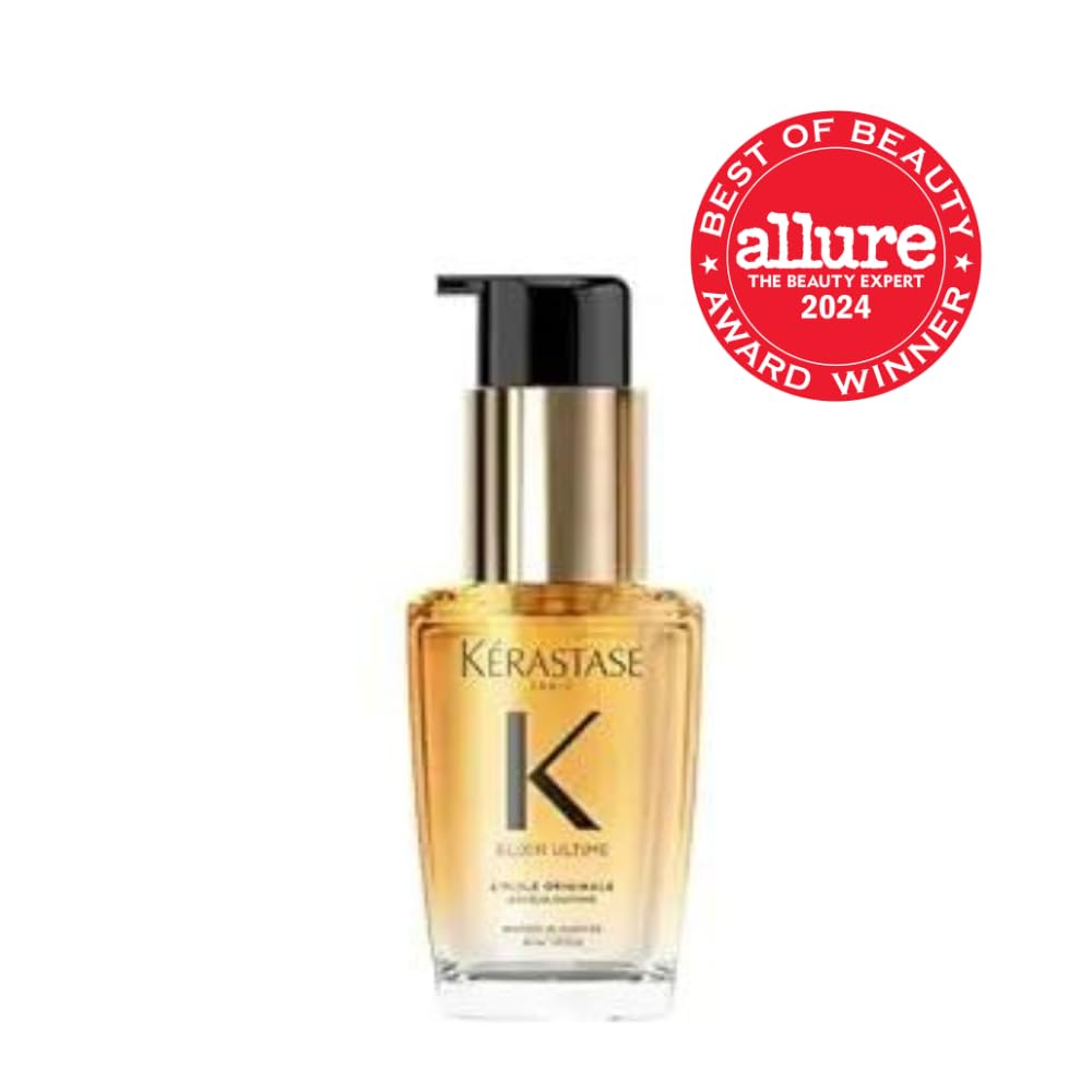 Close up of the KÃ©rastase Elixir Ultime hair serum bottle showing the liquid consistency and French camellia branding