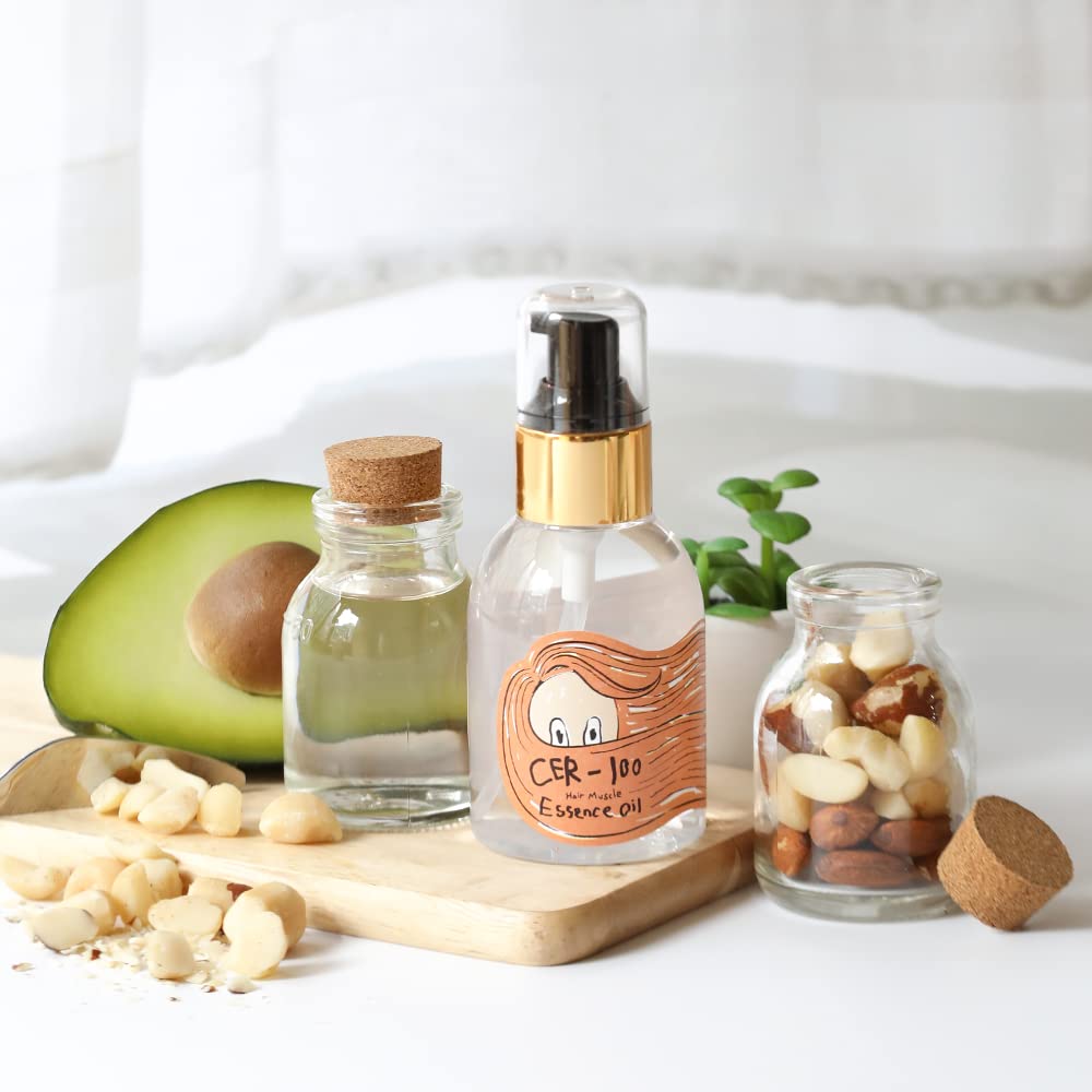 Elizavecca CER-100 hair treatment oil styled next to its outer cardboard box.
