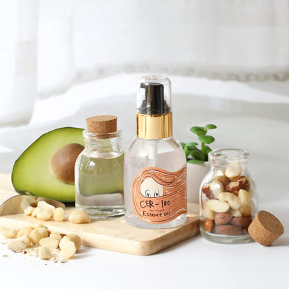 Elizavecca CER-100 hair treatment oil styled next to its outer cardboard box.