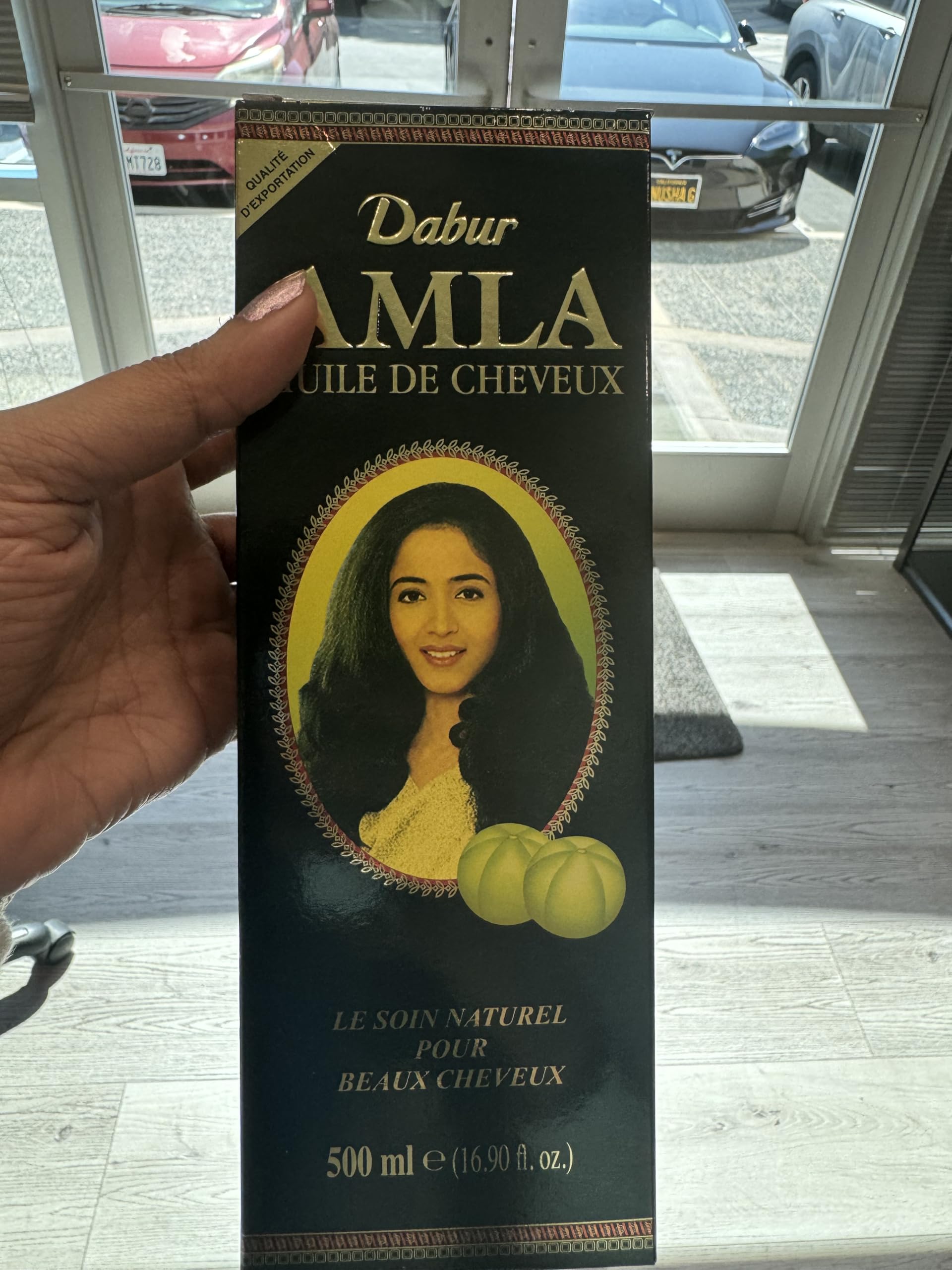 Dabur Amla nourishing herbal oil five hundred milliliter bottle showcasing product label details.