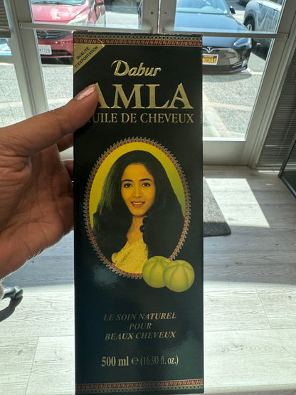 Dabur Amla nourishing herbal oil five hundred milliliter bottle showcasing product label details.