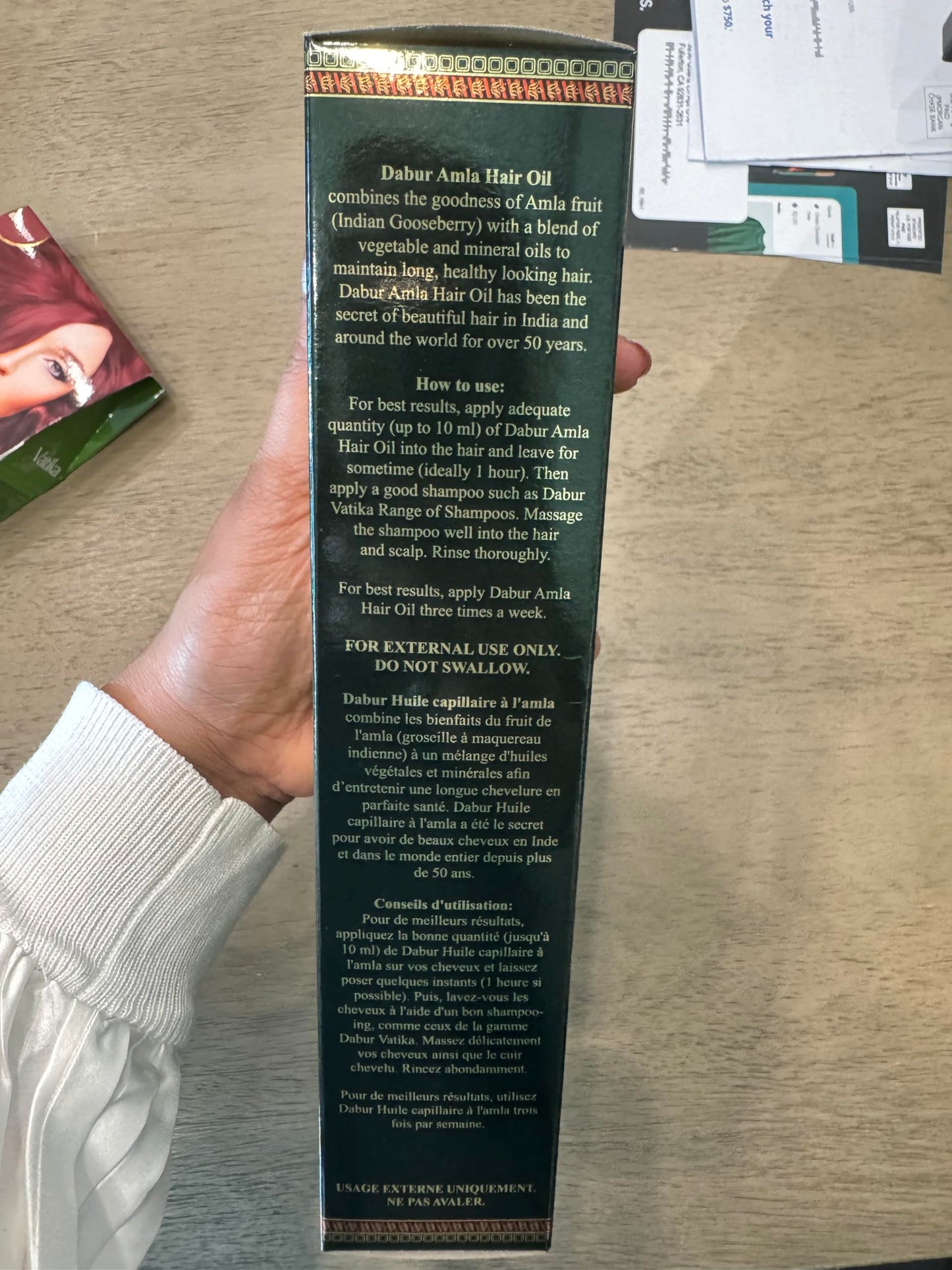 Back view of Ayurvedic root strengthening oil highlighting directions for use and ingredients.