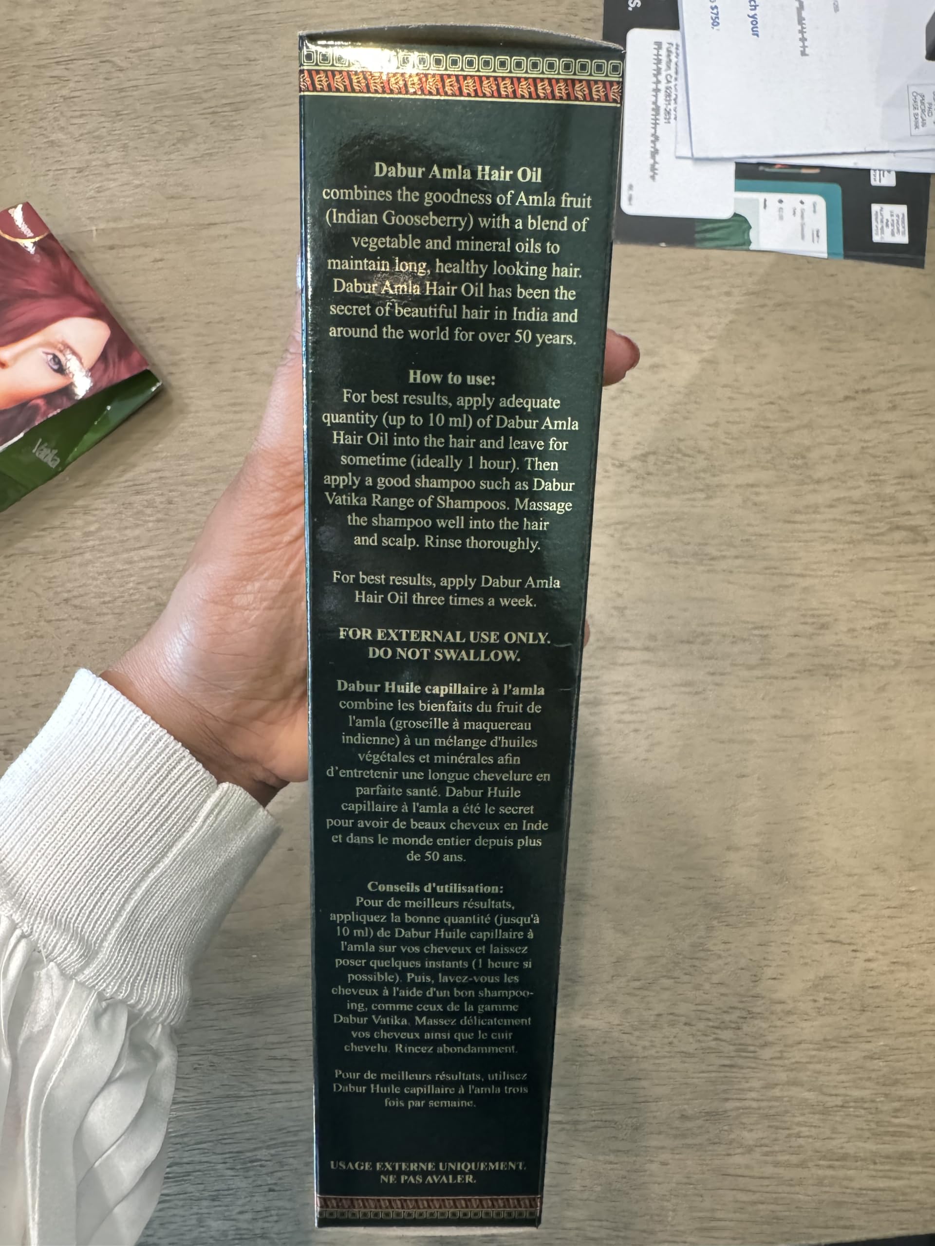 Back view of Ayurvedic root strengthening oil highlighting directions for use and ingredients.