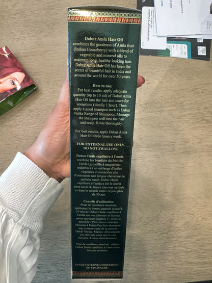 Back view of Ayurvedic root strengthening oil highlighting directions for use and ingredients.