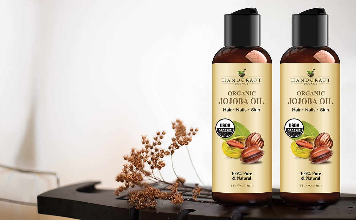 Handcraft Blends 4 fluid ounce organic jojoba oil bottle held to demonstrate size and texture.