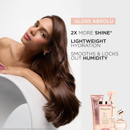 Application demonstration showing drops of the clear KÃ©rastase serum being dispensed into palms for styling.