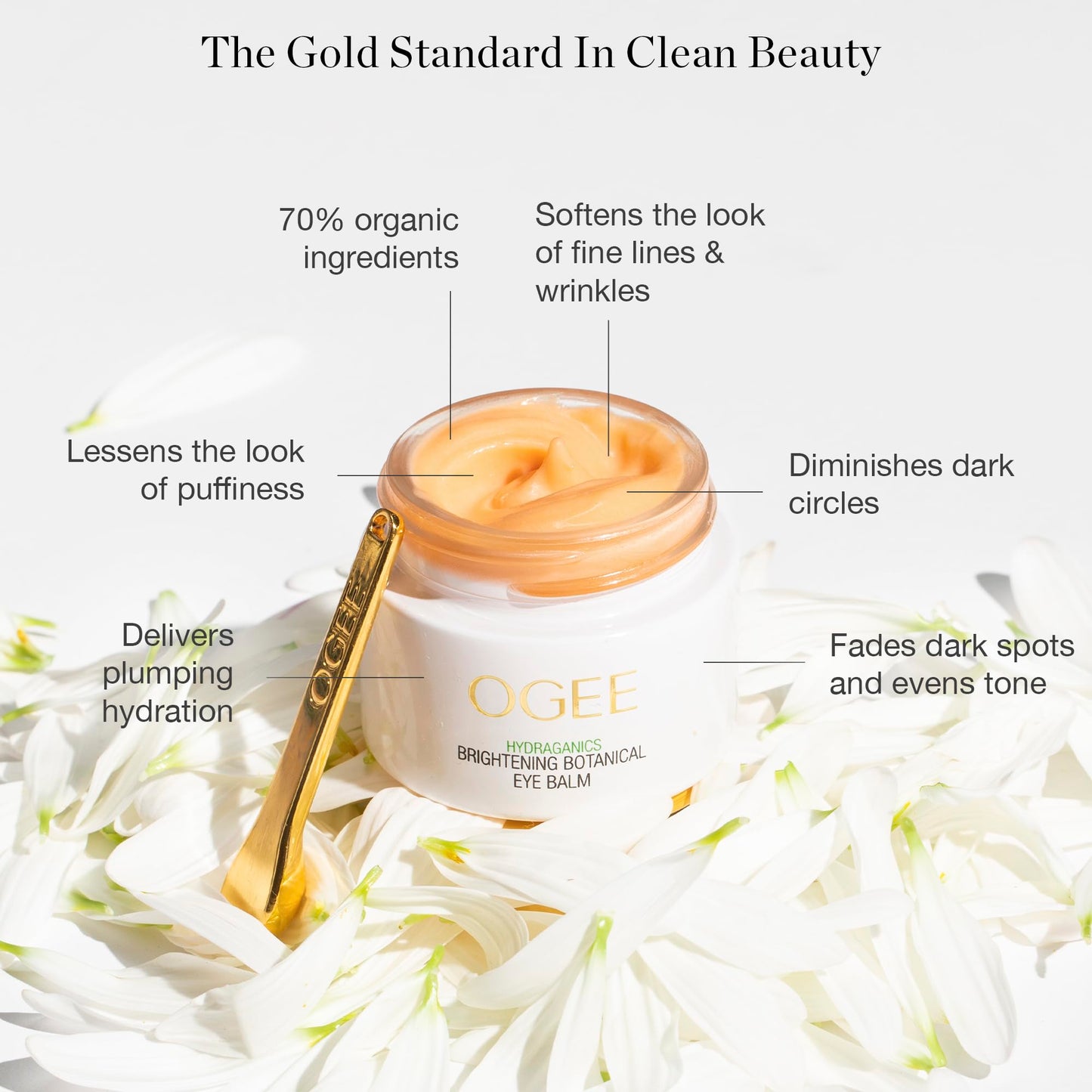 Ogee organic eye cream container with golden cooling massage applicator tool