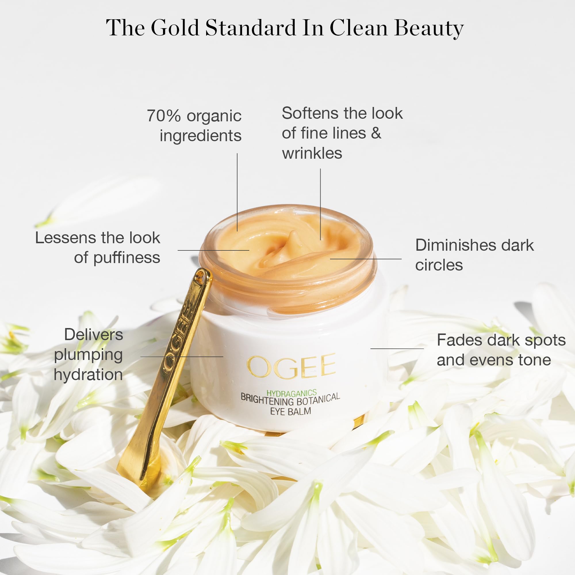 Ogee organic eye cream container with golden cooling massage applicator tool