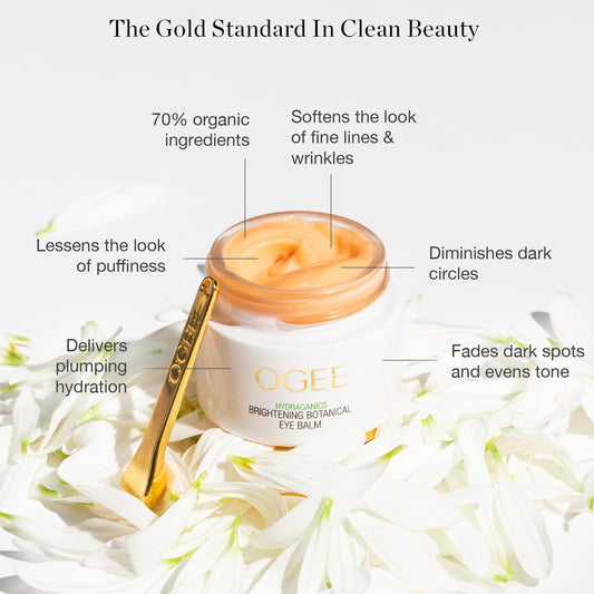 Ogee organic eye cream container with golden cooling massage applicator tool