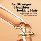 Fable and Mane HoliRoots strengthening serum dropper placing oil onto hands