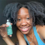Derma E scalp serum bottle displayed with natural tea tree leaves