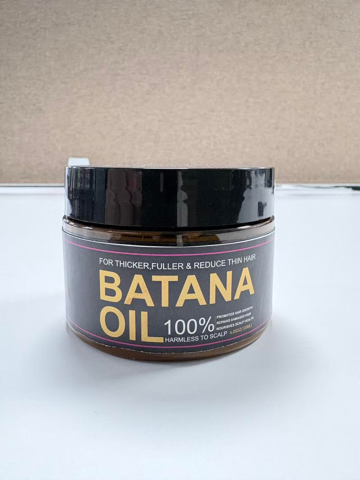 Qytin Batana Oil back view showing ingredients and instructions
