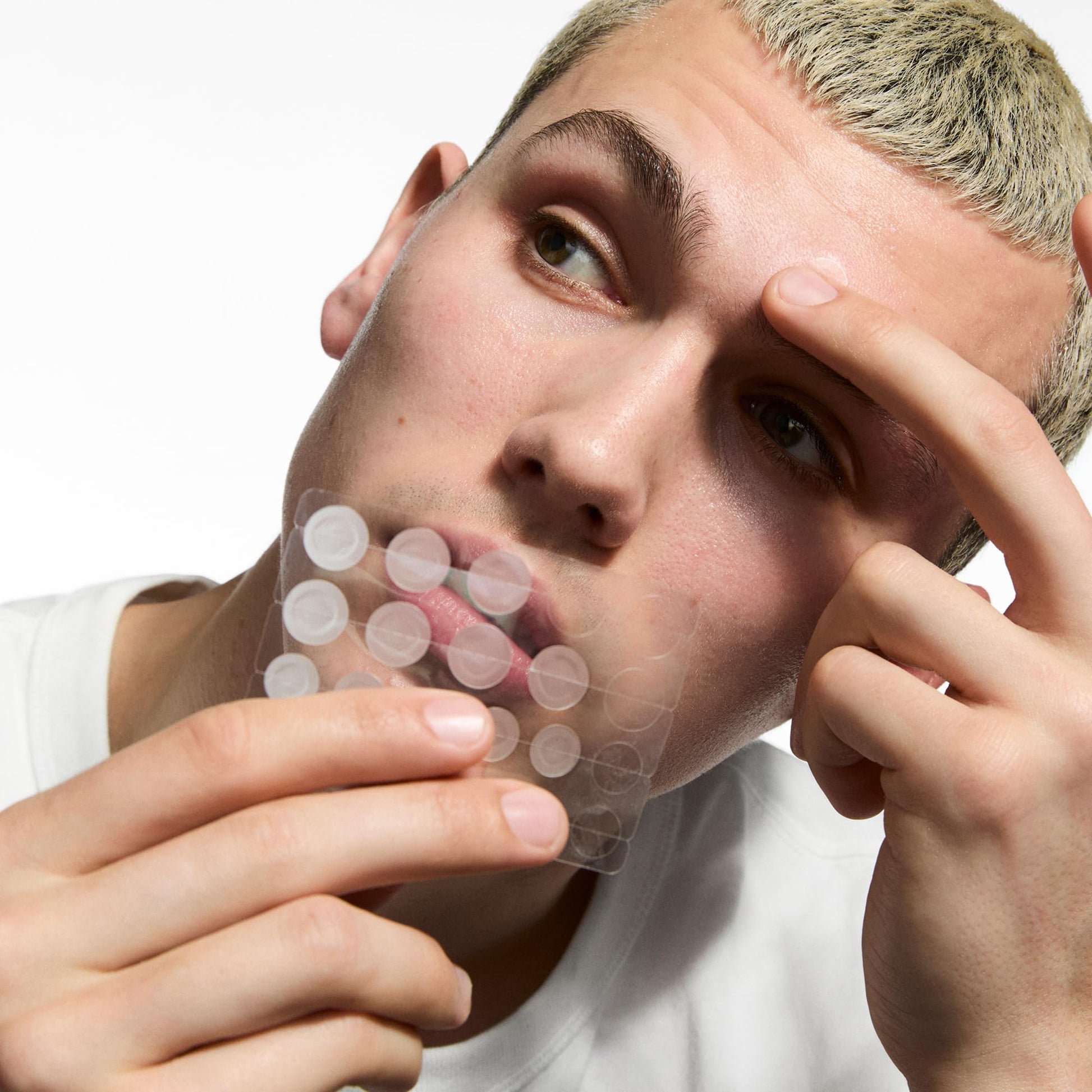The INKEY List hydrocolloid invisible pimple patches consumer presentation box next to the active ingredient benefits