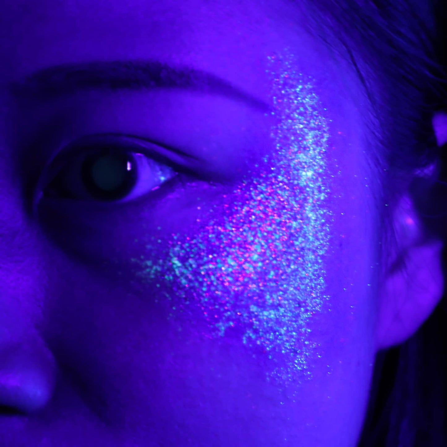 LATIBELL UV reactive cosmetic glitter glowing brightly under a night party blacklight