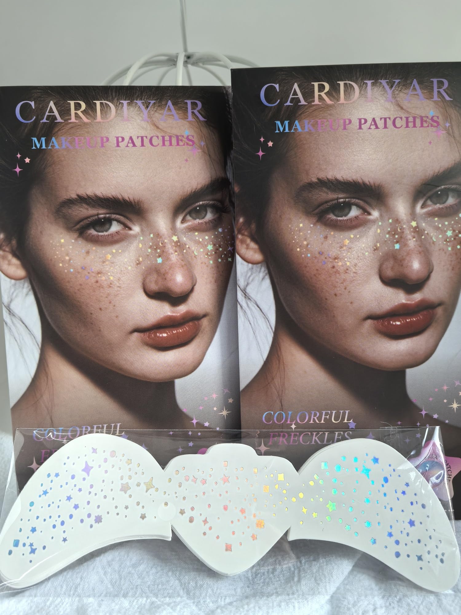 Different sheets of Cardiyar temporary makeup patches featuring diverse festival glitter designs.