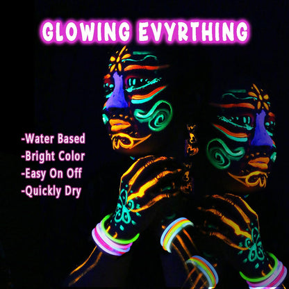 Six tubes of fluorescent neon body paint glowing brightly under a blacklight source