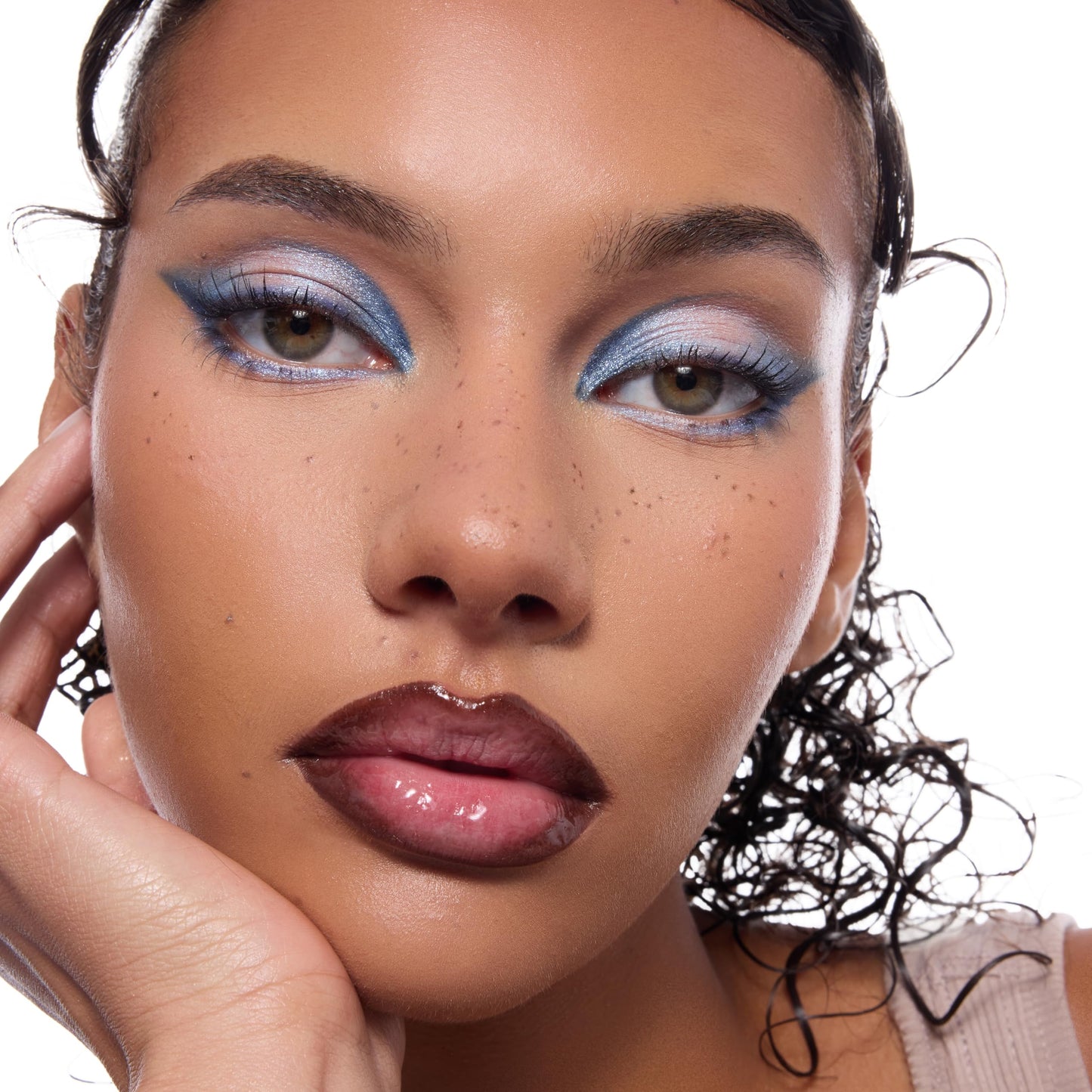 Uncapped long-lasting fake freckles makeup pen demonstrating the flexible tip designed for custom dotting.