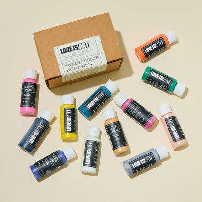 Twelve pack of non-toxic intimacy safe water-based paint bottles by Love is Art displayed together.