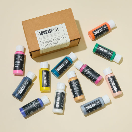 Twelve pack of non-toxic intimacy safe water-based paint bottles by Love is Art displayed together.