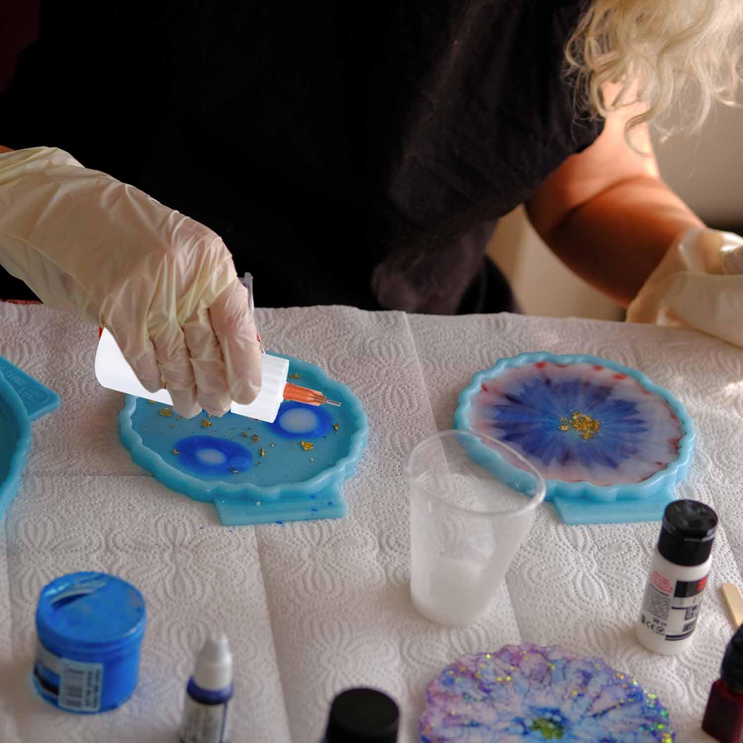 Ruibow craft dispenser kit being utilized for precise liquid glue application on a delicate DIY project.