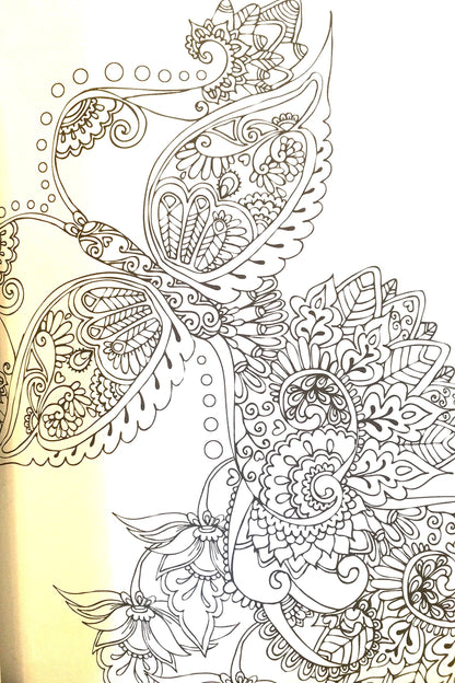 Detailed view of single sided intricate black background paisley illustrations inside the adult coloring book