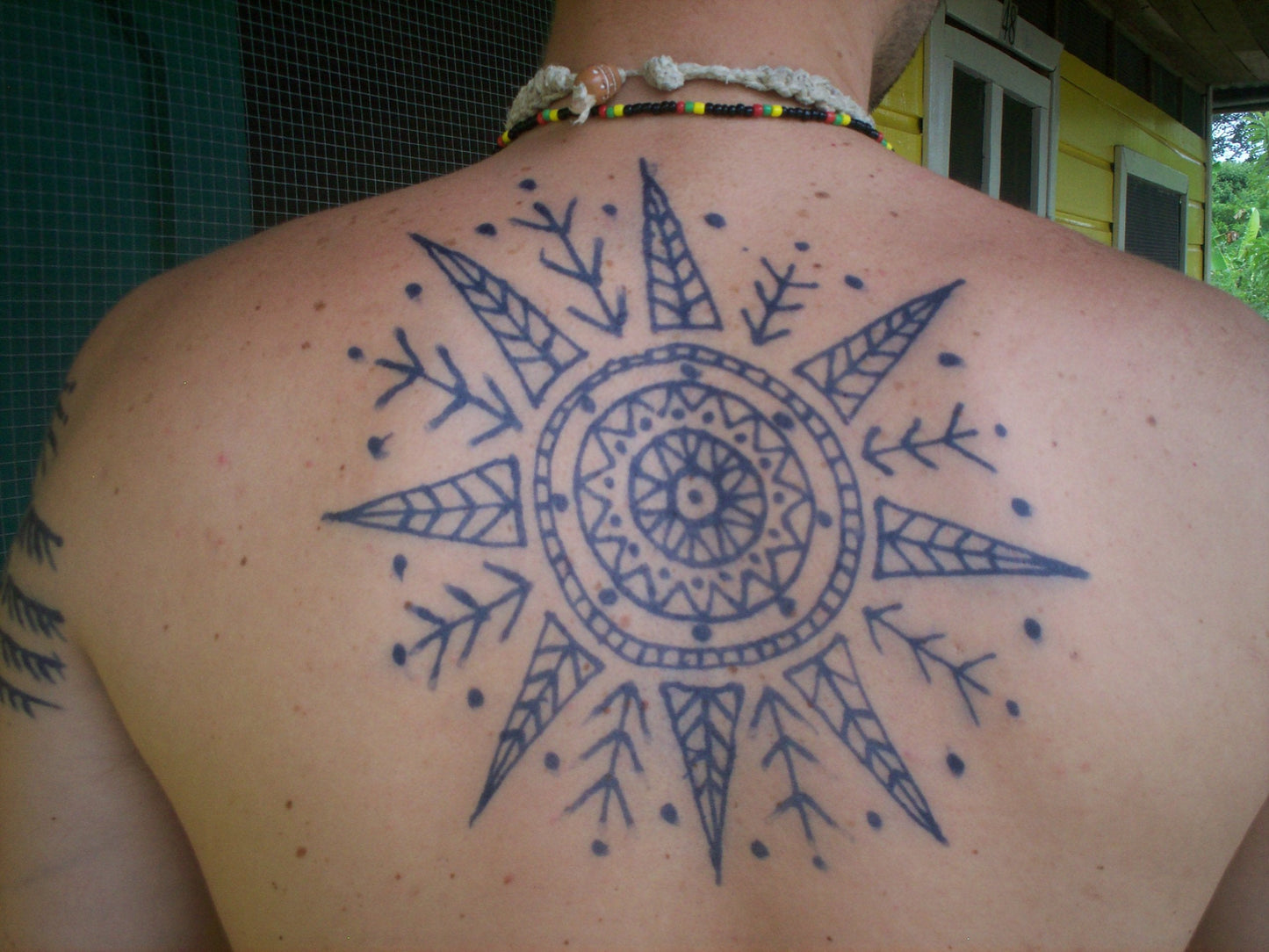 Authentic dark blue black natural tattoo stain result on skin surface