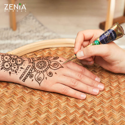 Person applying Zenia henna paste for temporary freckles