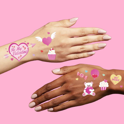 Detailed view of BE MINE and candy heart tattoo designs.