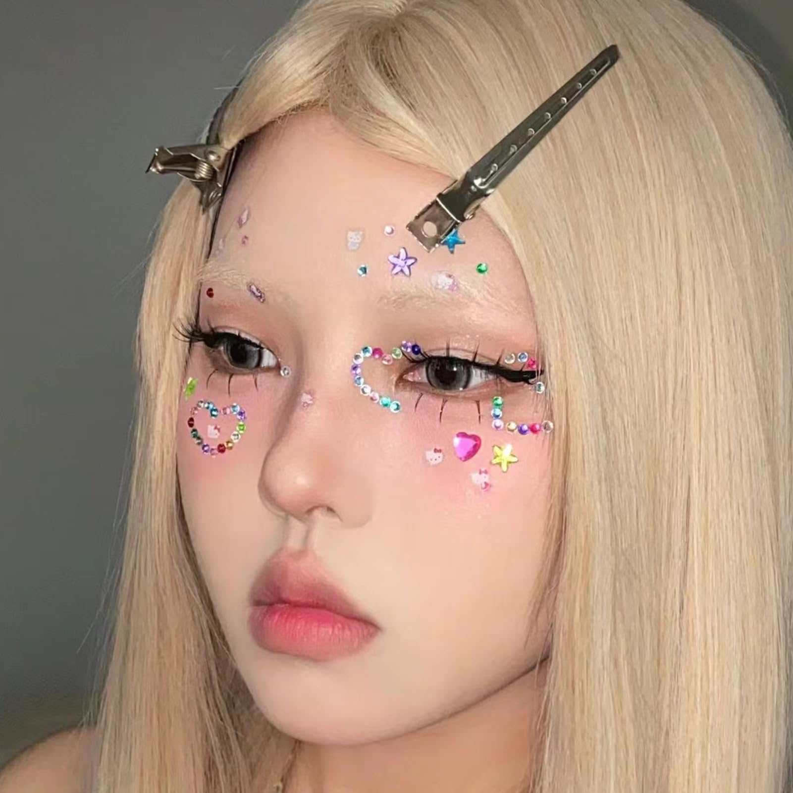 Applying self-adhesive jewels for creative eye makeup
