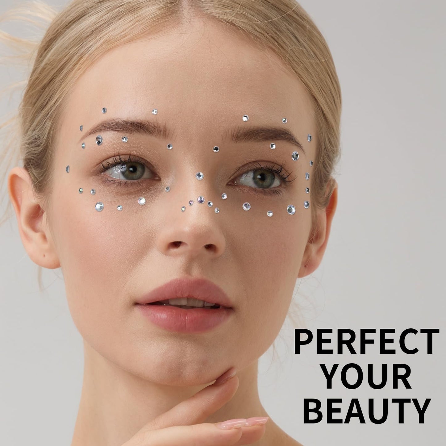 Application of star face gems near eyes for festival makeup
