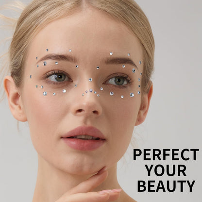 Application of star face gems near eyes for festival makeup