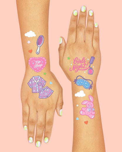 Girl showing off sleepover themed temporary tattoos