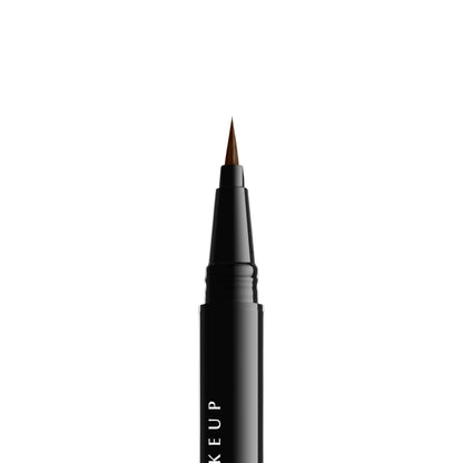 The micro-brush applicator drawing fine lines on skin to display buildable pigment density.