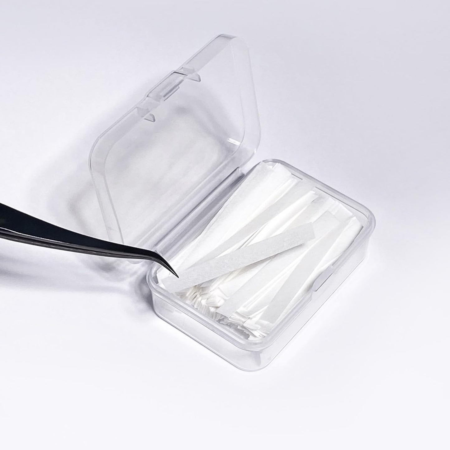 Authentic USA imported PERMANIA lash lift paper strips highlighting the texture designed to prevent hair slippage.