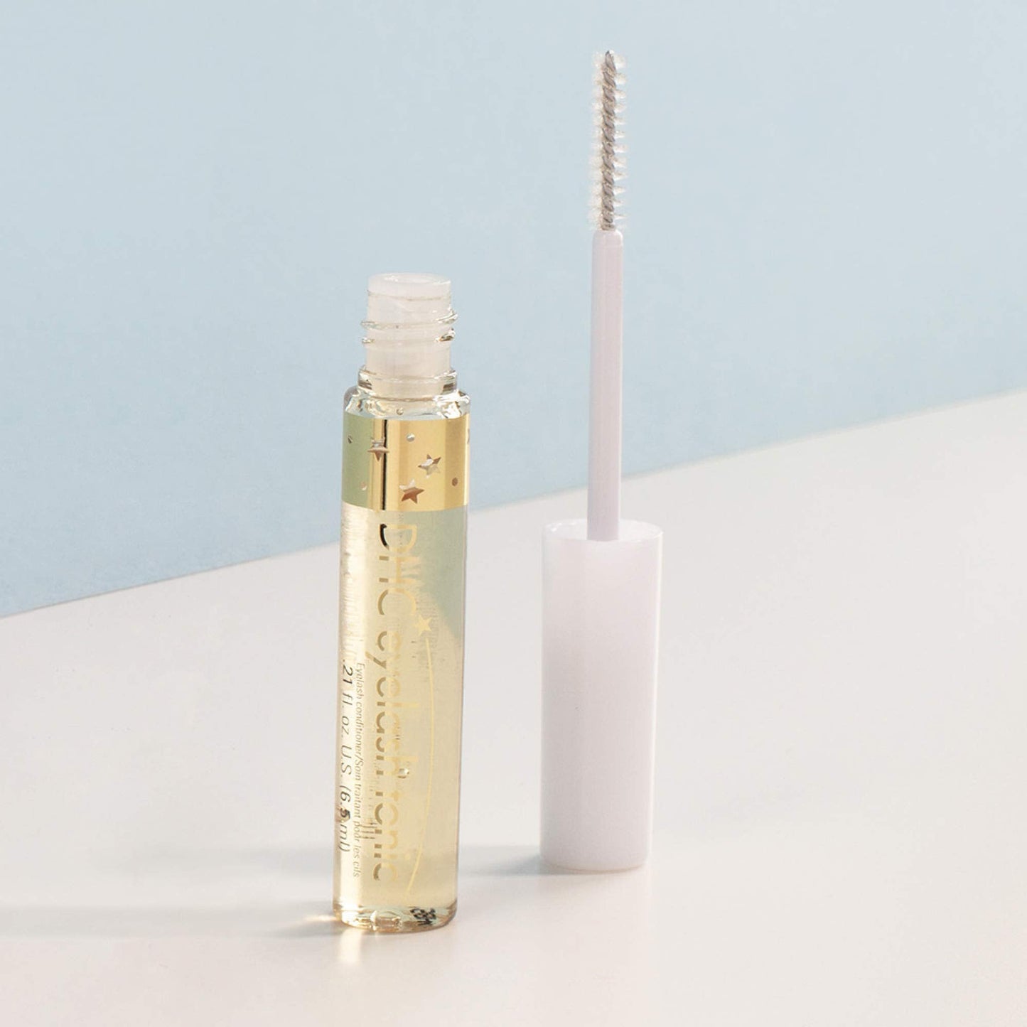 DHC lash growth serum bottle with premium gold accents