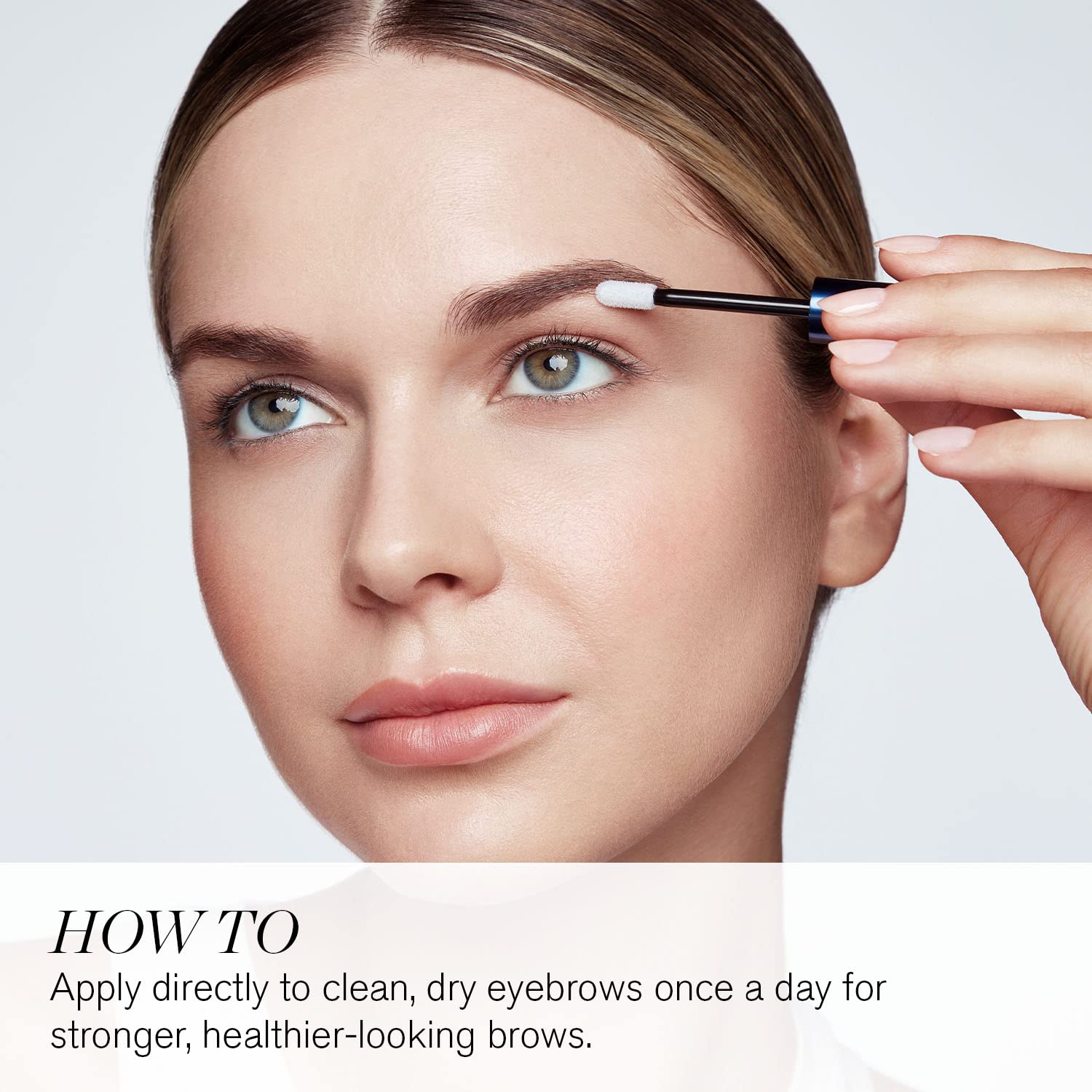 RevitaBrow Advanced 3ml eyebrow conditioner tube lying flat on clean background