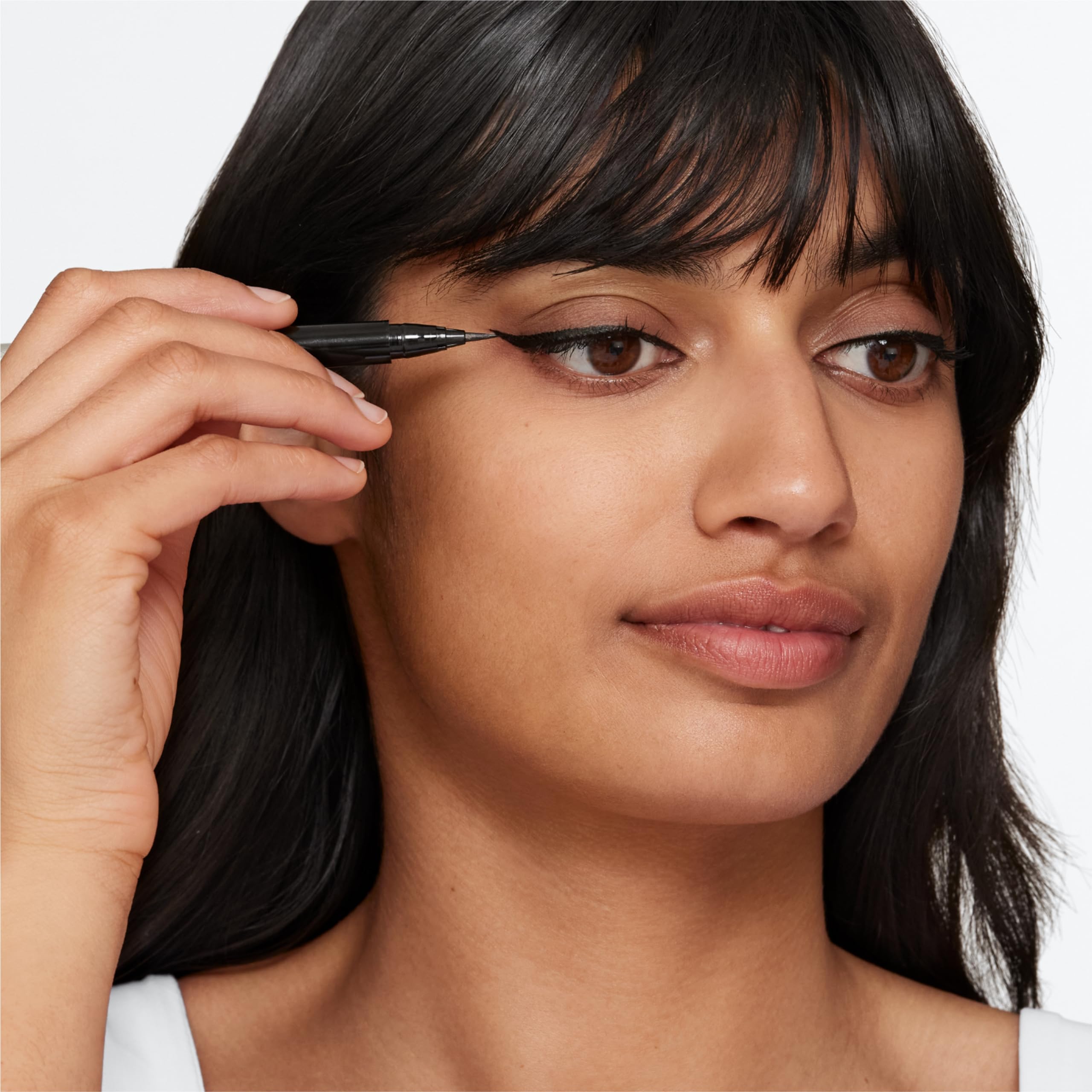 Clinique sensitive eyes makeup pen being held to demonstrate the comfortable ergonomic control grip.