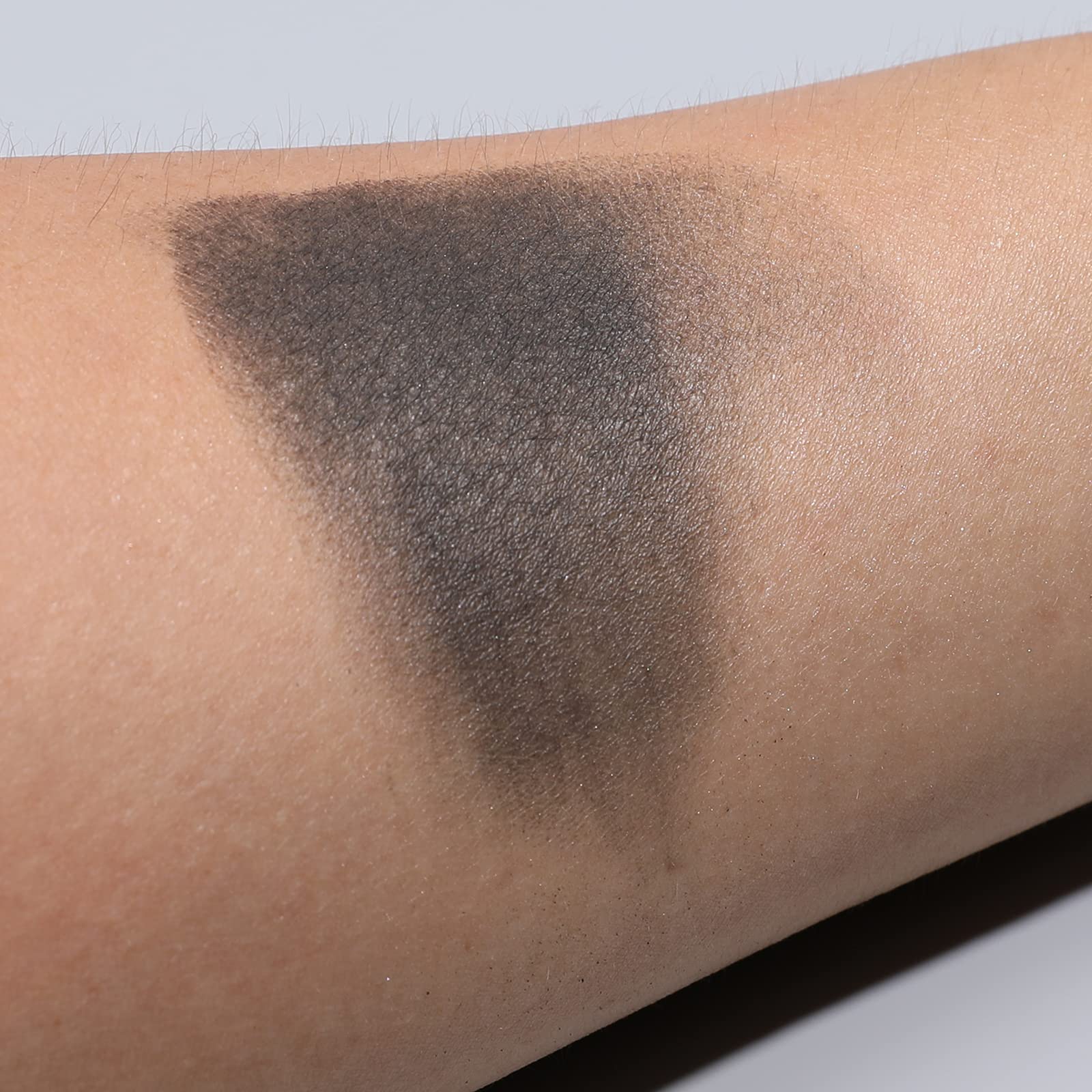 Is'Mine black eyeshadow swatch on skin