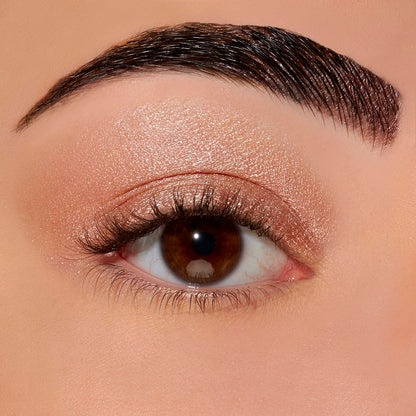 Sigma Beauty eyeshadow base primer swatch on skin illustrating pinky-peach payoff