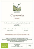 Measurement of two teaspoons of loose chamomile flowers prepared for a wellness brew.