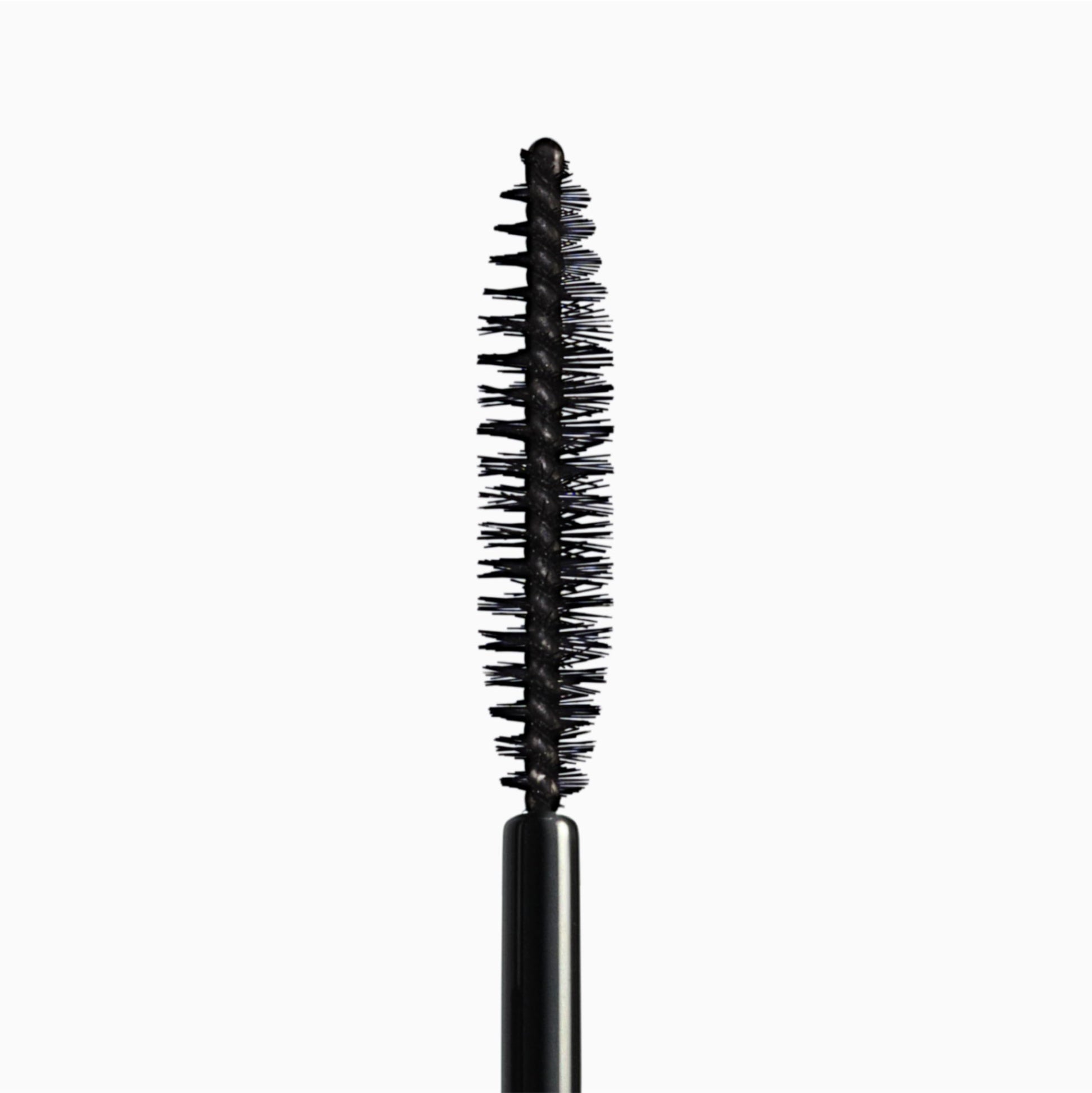 Smudge proof tubing mascara tube placed alongside its formal outer product packaging box