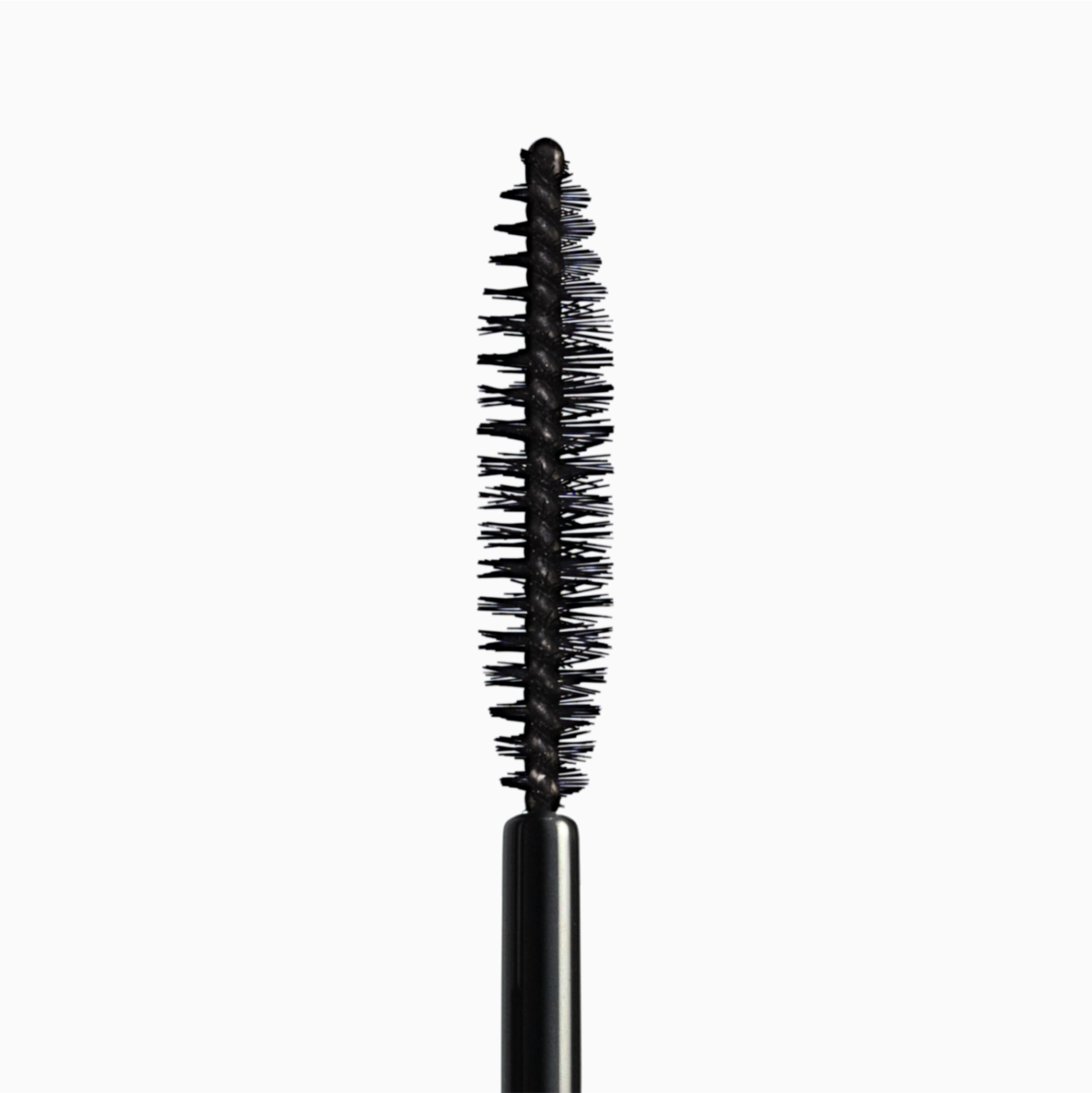 Smudge proof tubing mascara tube placed alongside its formal outer product packaging box