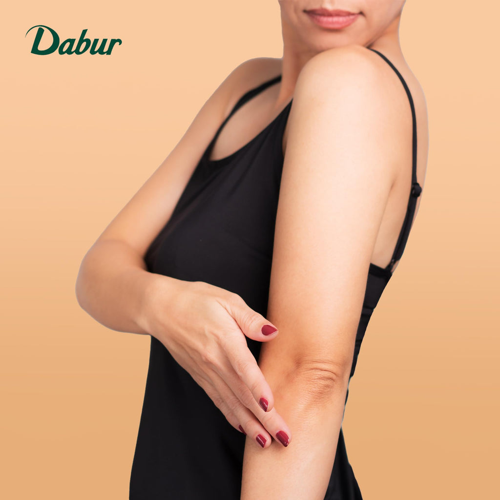 Applying Dabur Herbolene Petroleum Jelly to dry skin