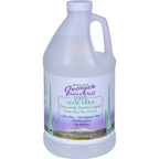 Authentic imported George's aloe vera distillate clear supplement bottle displayed on a white wellness counter