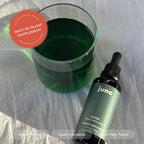 Authentic USA imported Juna chlorophyll bottle displayed on a minimalist clean health vanity setup