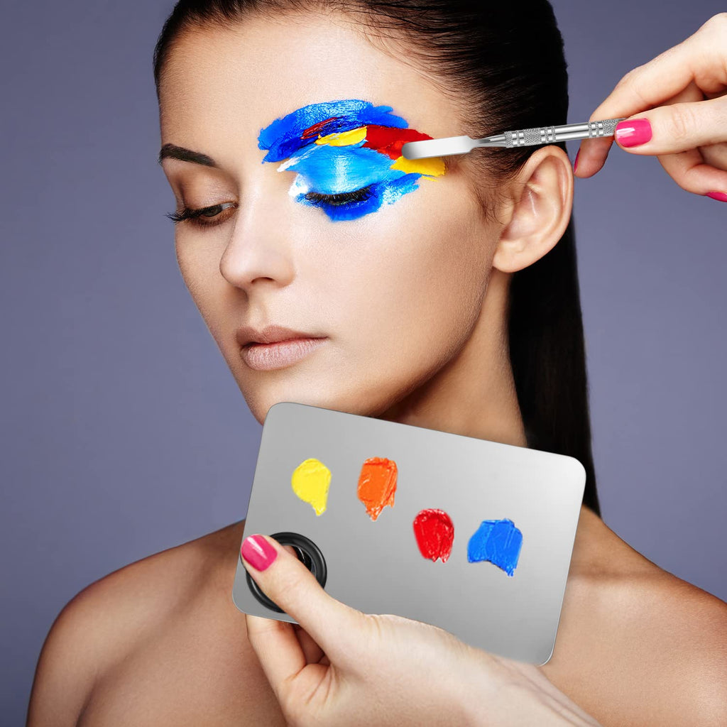 Compact portable makeup mixing palette held in hand during application.