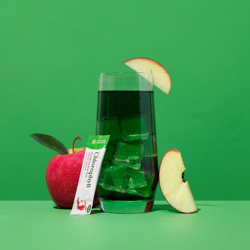 Premium green powder dietary supplement single-serve packets on a white backdrop