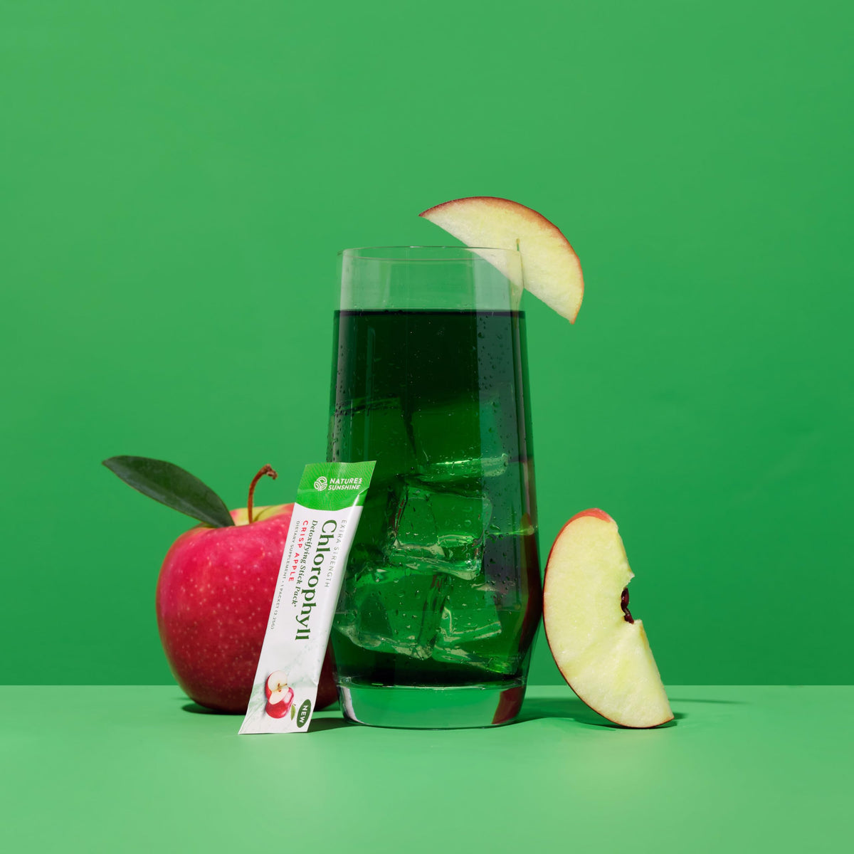 Premium green powder dietary supplement single-serve packets on a white backdrop